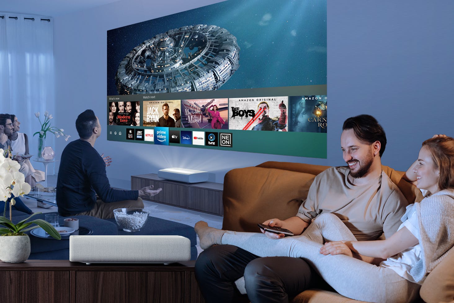 A Collage of friends enjoying a movie night, a couple and Samsung's The Premiere 4K Laser Projector